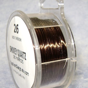 May include: A spool of 26 gauge non-tarnish wire in the color Smokey Quartz. The spool contains 30 yards of wire and is labeled "Supply and Design Etsy.com Premium Quality Wire".