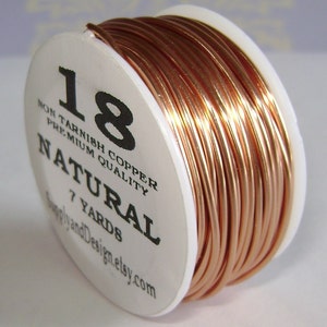 May include: A spool of 18 gauge non-tarnish copper wire in natural color. The spool is labeled "18 Non Tarnish Copper Premium Quality Natural 7 Yards SupplyandDesign.etsy.com".