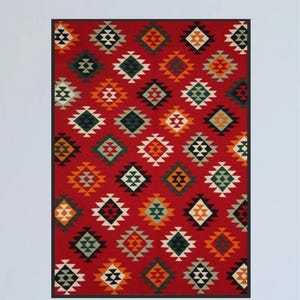 May include: A red rug with a geometric pattern of black, white, green, and orange squares and triangles.