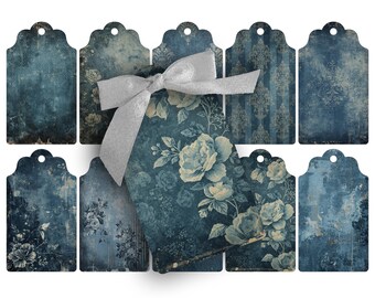 May include: A collection of vintage-style gift tags in shades of blue and cream. The tags feature distressed textures, floral patterns, and a decorative silver ribbon. The tags are ideal for adding a touch of elegance to gifts or crafts.
