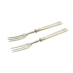 May include: Two silver serving forks with ornate handles. The forks have three tines each.