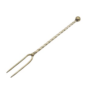 May include: A vintage-style cocktail fork with a twisted stem and a small ball at the end. The fork has two tines and is made of a metallic material with a gold finish. The design is simple and elegant, suitable for serving appetizers or garnishes.