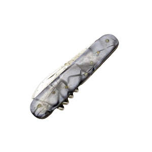 以下が含まれることがあります： シルバーの刃とグレーとシルバーのハンドルが付いたヴィンテージのポケットナイフ。ハンドルは大理石模様で、小さな真鍮製のピンでリベット留めされています。ハンドルの根元にはコルクスクリューが見えます。