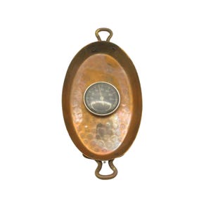 May include: A copper oval baking dish with two handles and a built-in thermometer. The thermometer has a black face and a silver needle.