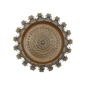 May include: A round, antique bronze tray with an intricate floral pattern in the center. The tray has a raised edge with decorative metalwork around the perimeter. The overall design is ornate and detailed.