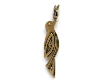 May include: A gold-toned metal bird sculpture with intricate details and the word "Muse" written on the top.