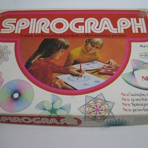 May include: A vintage Spirograph drawing set box with a red, white and pink design. The box features a Spirograph logo and the text "A simple and fascinating way to draw a million marvelous patterns." The box also features images of children using the Spirograph set to create colourful designs.