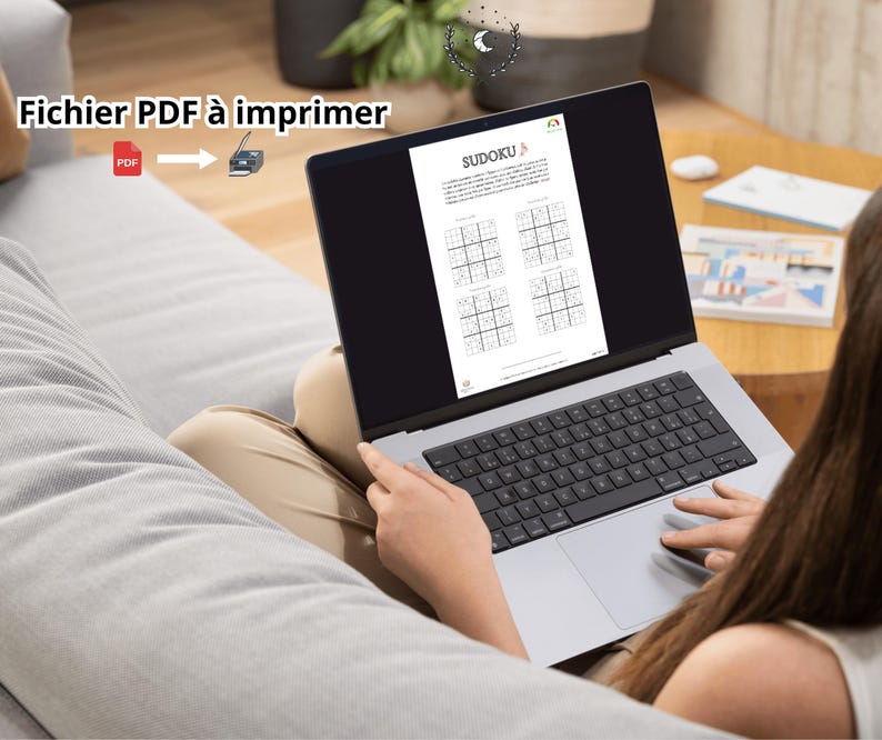May include: A silver laptop displaying a Sudoku puzzle document on its screen. The screen shows the title Sudoku and four grid puzzles. Text on the image reads Fichier PDF &agrave; imprimer with a red PDF icon and a printer icon with an arrow.