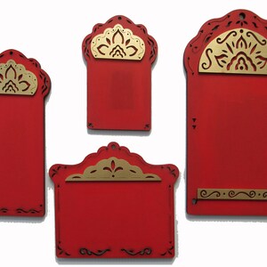 May include: Four red wooden signs with gold decorative accents. The signs have a scalloped top and a decorative border. The signs are blank and ready to be personalized.