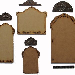 May include: Set of six unfinished wood craft tags with intricate cut-out designs. The tags are in various shapes and sizes, including rectangular, arched, and half-circle. The tags are perfect for adding personal touches to gifts, crafts, and home decor.