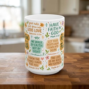 May include: White ceramic mug with inspirational quotes and floral accents. The mug features phrases like "Have Faith in God" and "The Lord is my Rock & my Fortress." The design includes orange, green, and purple elements.