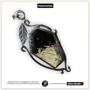May include: A silver pendant with a black and white agate stone set in a silver frame. The pendant has a leaf design on the side and a bail for attaching a chain.