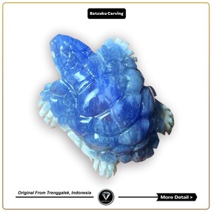 May include: A blue and white carved turtle figurine made from natural stone. The turtle is detailed with a textured shell and is a traditional style of carving.