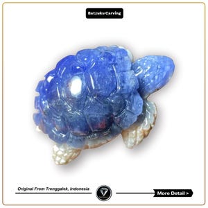 May include: A blue and white carved turtle figurine made from natural stone. The turtle is a symbol of longevity and good luck in many cultures.