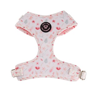 A soft, adjustable dog harness featuring a charming pink floral design, breathable mesh interior for comfort, and sturdy construction for secure walks.