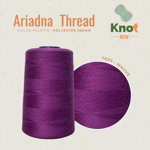 May include: A large spool of mauve polyester thread labeled Ariadna Thread, Knot Now, and T030 - Mauve. The spool contains 5000m of thread. The thread is a deep, solid purple-toned mauve color with a smooth, consistent texture wound around the core.