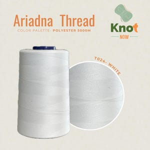 May include: A large spool of white Ariadna polyester thread labeled 5000M. The image includes the text Ariadna Thread, Color Palette- Polyester 5000M, Knot Now, and T024- White. The thread is wound onto a cylindrical spool with a dark top.