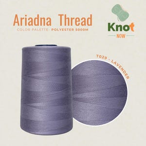 May include: A large spool of lavender polyester thread labeled Ariadna Thread, Knot Now, and T029 - Lavender. The thread is 5000m in length. The spool is cylindrical with a smooth, matte finish, showcasing a consistent light purple color throughout.
