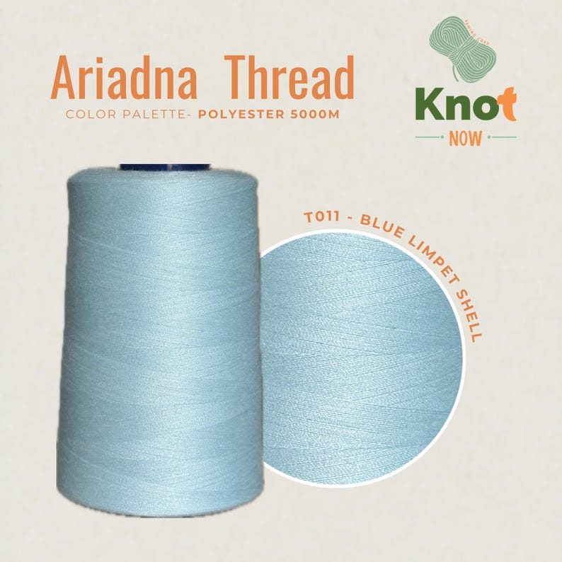 May include: A large spool of light blue polyester thread labeled Ariadna Thread, Knot Now, and T011 - Blue Limpet Shell. The spool contains 5000m of thread, featuring a smooth, consistent texture in a soft, pale blue color suitable for sewing projects.