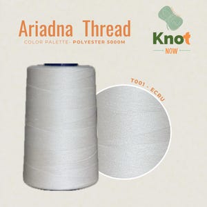 May include: A large spool of white Ariadna polyester thread with 5000M printed on the label. The text reads Ariadna Thread, Knot Now, and T001 - ECRU. The thread is wound in a cylindrical shape with a dark top cap, showing a smooth texture.