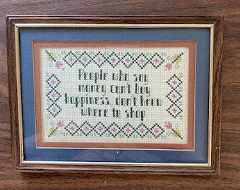 Framed Counted Cross Stitch, Saying “money can’t buy happiness “, 8” x 6” overall, 1990s.