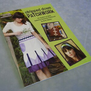 May include: Stripped Down Patchwork book cover featuring 12 modern projects featuring Seminole Patchwork by Erin Gilday. The cover shows a woman wearing a purple and white patchwork skirt.