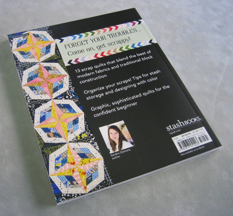 May include: Book cover with a black background and a colorful quilt design. The title is "Forget Your Troubles... Come on, get scrappy!" and the subtitle is "13 scrap quilts that blend the best of modern fabrics and traditional block construction". The author is Sandra Clemons.