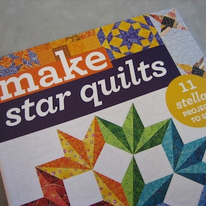 May include: Book cover with the title "Make star quilts" and a colorful quilt design featuring a variety of star patterns. The cover also includes the text "11 stellar projects to sew".