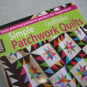May include: A book titled "Simple Patchwork Quilts" with a colorful patchwork quilt on the cover. The book is part of the "Best of Quiltmaker" series and is for beginners.