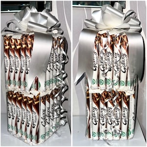 May include: A gift box made of Galaxy Ripple chocolate bars, wrapped with silver ribbon and a large bow. The chocolate bars are arranged to resemble a present, perfect for a chocolate lover.