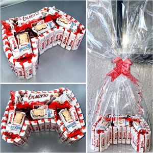 Könnte beinhalten: Ein Schokoladen-Geschenk-Korb in Form eines Videospiel-Controllers. Der Korb besteht aus Kinder-Schokoladentafeln und enthält eine Bueno-Schokoladentafel. Der Korb ist in Klarsichtfolie verpackt und mit einem roten Band gebunden.