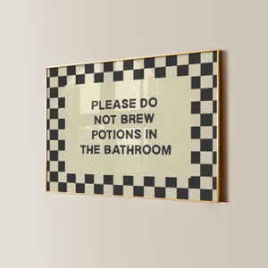 Cute witch Halloween bathroom sign with a funny potion brewing message for spooky season decorating. This witchy wall art is ideal for kids Halloween bathroom decor, children’s Halloween parties, witch themed party decorations, and potion party decor. A whimsical way to decorate a bathroom for Halloween with magical witch decor, funny bathroom decor, fall decorations, and playful kid friendly Halloween style.