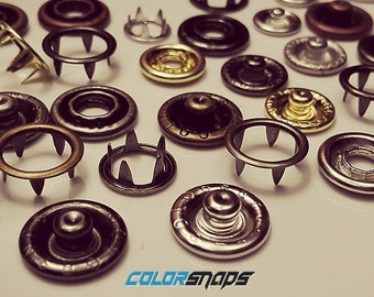 Broches de latón • Talla 16 • Talla 14 • Talla 12 • 13/32 • 3/8 • 9/32 • Anillo • Punta • Sin coser • Botón de presión • Dorado • Negro • Bronce • Antiguo • Plateado