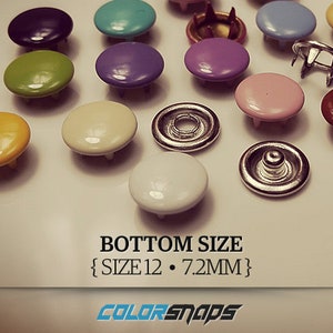 May include: Assortment of colorful metal snaps with a silver base. The snaps are arranged on a white surface. The text "BOTTOM SIZE {SIZE 12. 7.2MM}" is printed below the snaps. The text "COLORSNAPS" is printed below the size information.