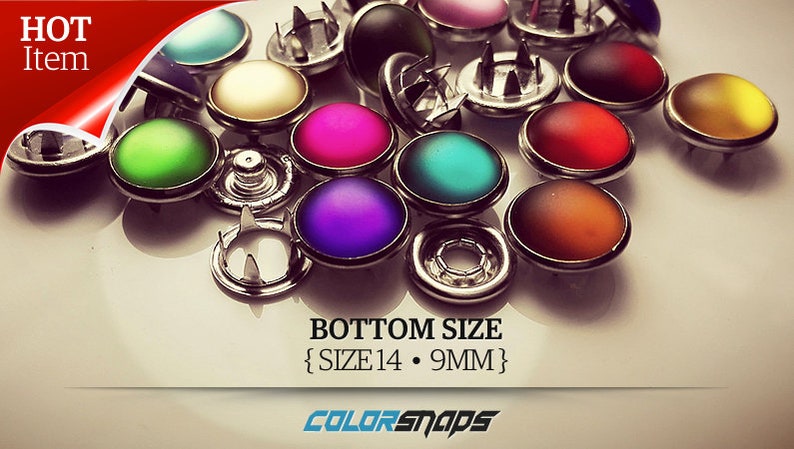 May include: A collection of colorful Color Snaps buttons with a metallic base. The buttons are in various colors, including green, pink, purple, and yellow. The text "HOT Item" is in the upper left corner. The bottom size is 14, which is 9mm.