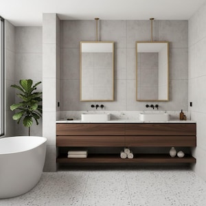 May include: A bathroom featuring a double vanity with a dark wood cabinet, white marble countertop, and two rectangular white sinks. Two rectangular mirrors with gold frames hang above the sinks. A white freestanding bathtub sits to the left.