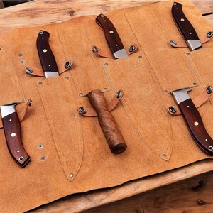 Protective leather knife roll, prevents damage"
"Convenient leather knife storage, easy access"
"Travel-friendly leather knife case, compact design"
"Durable leather knife roll, withstands heavy use"
Stylish leather knife storage, kitchen decor