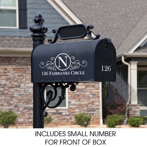May include: Black mailbox with a white monogram sticker featuring the letter "N" in a circle and the text "126 Fairbanks Circle". The mailbox also has a white number "126" on the side.