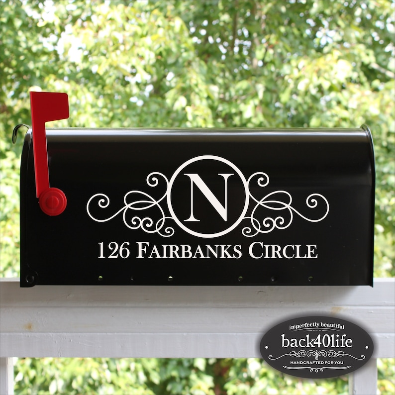 May include: Black mailbox with a white vinyl decal featuring a decorative swirl design, the letter "N" in a circle, and the address "126 FAIRBANKS CIRCLE".