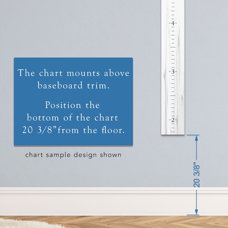 May include: A white wooden growth chart with black markings, showing measurements in inches. The chart is mounted on a wall above a white baseboard. Text on the wall reads: "The chart mounts above baseboard trim. Position the bottom of the chart 20 3/8" from the floor. chart sample design shown"