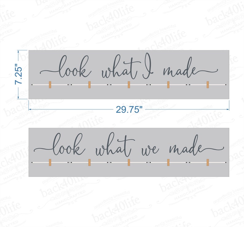 May include: Two gray wooden signs with the text "look what I made" and "look what we made" in cursive script. Each sign has a row of small wooden dowels.