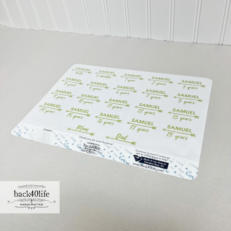 May include: A sheet of stickers with green text and arrows. The stickers are for a baby named Samuel and show his age from birth to 18 years. The stickers say "Samuel" and the age in years, with the words "Mom", "Dad", and "Celadon" at the bottom.