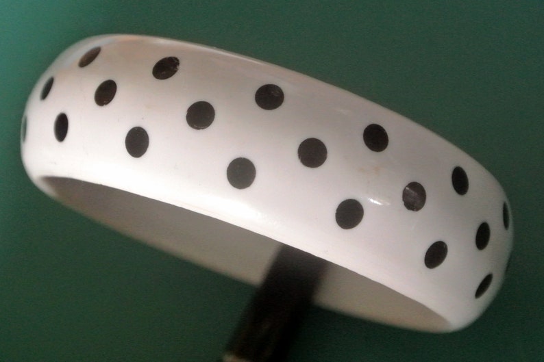 Vintage 1980s unused moulded bone white black lucite plastic bangle bracelet with polka dot decor