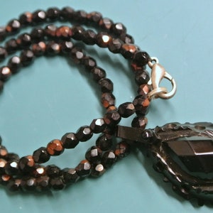 Lovely vintage 1970s grinded faceted partly copper-foiled black glass bead necklace with dropformed grinded stone pendant