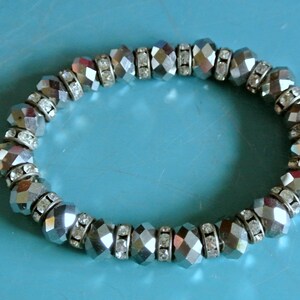 Vintage 1990s unused stretch bracelet with gray faceted grinded round crystal beads and faceted clear rhinestone rondellen between beads