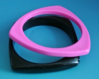 Pair of vintage 1990s unused triangular pink/ square black lucite plastic bangle bracelets