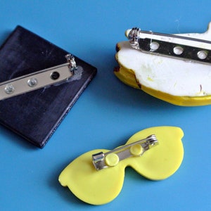 Lot of 3 vintage 1950s unused small lucite plastic yellow/ black or brown brooches with banana/sunglass/abstract motive and securety needle image 2