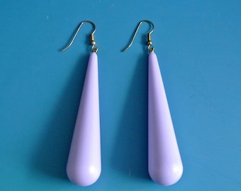 May include: A pair of lavender teardrop-shaped earrings with gold hooks.