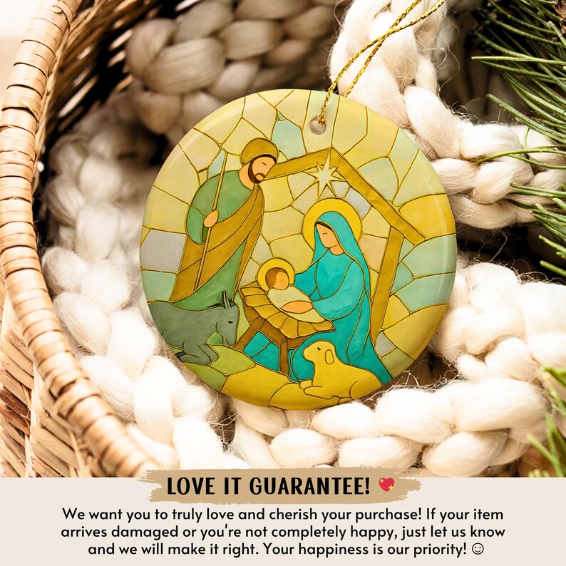May include: A round Christmas ornament with a stained-glass style depiction of the Nativity scene. The ornament features Mary, Joseph, baby Jesus, a donkey, and a lamb. The ornament has a gold string for hanging.