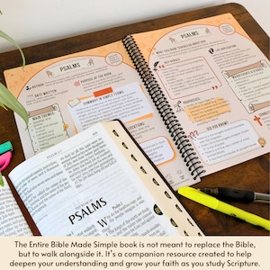 May include: Open Bible study guide with the title "Psalms" and detailed notes. The spiral-bound book is open to reveal colorful diagrams, key verses, and summaries. A highlighter and pen rest on the pages, alongside a separate bookmarked section.